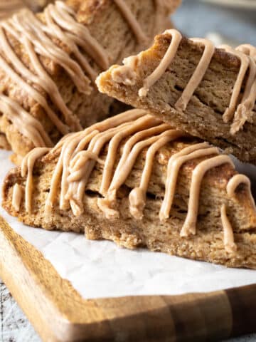 Cinnamon scones with a cinnamon glaze on a board.