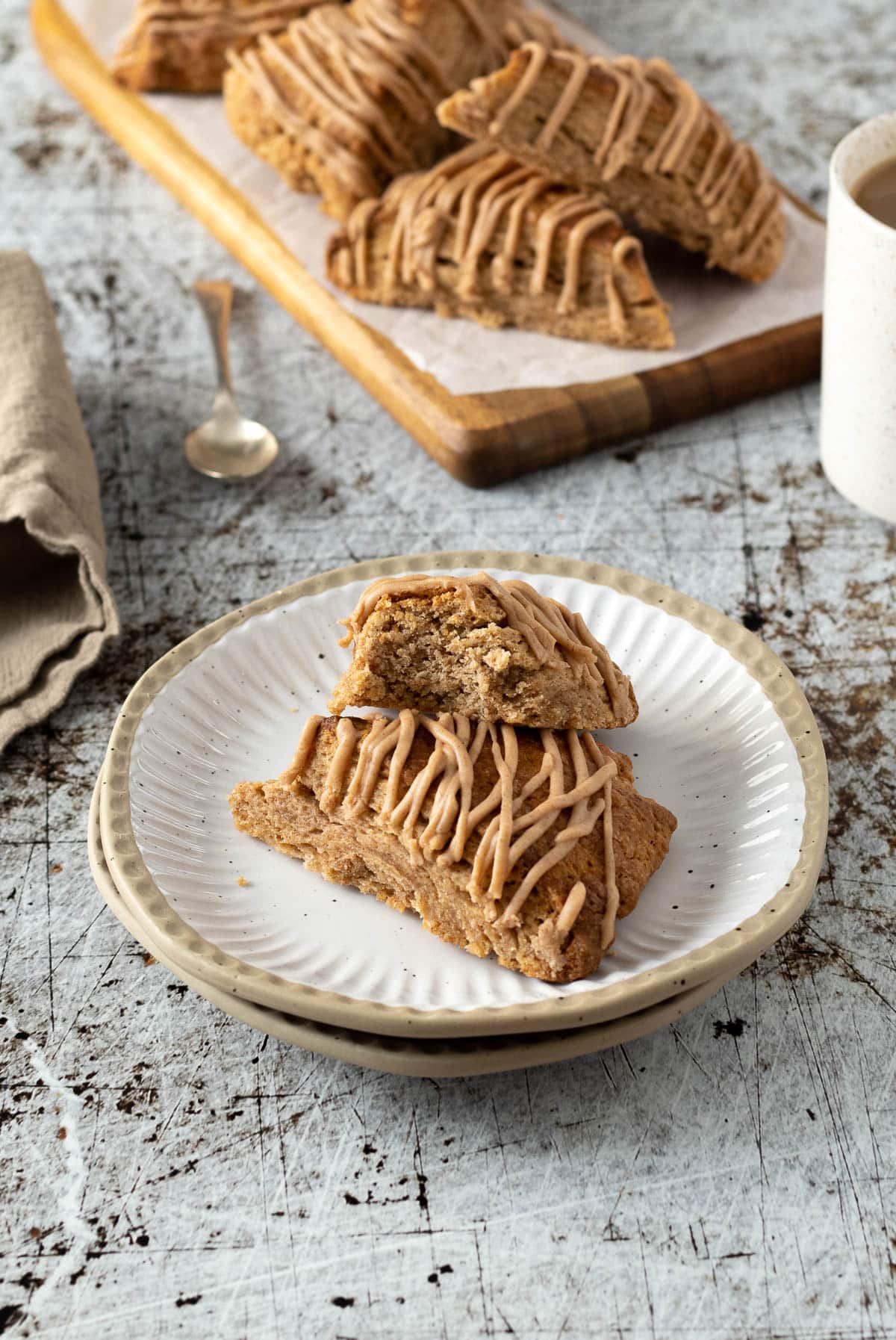 Scones with cinnamon with cinnamon glaze on a plate.