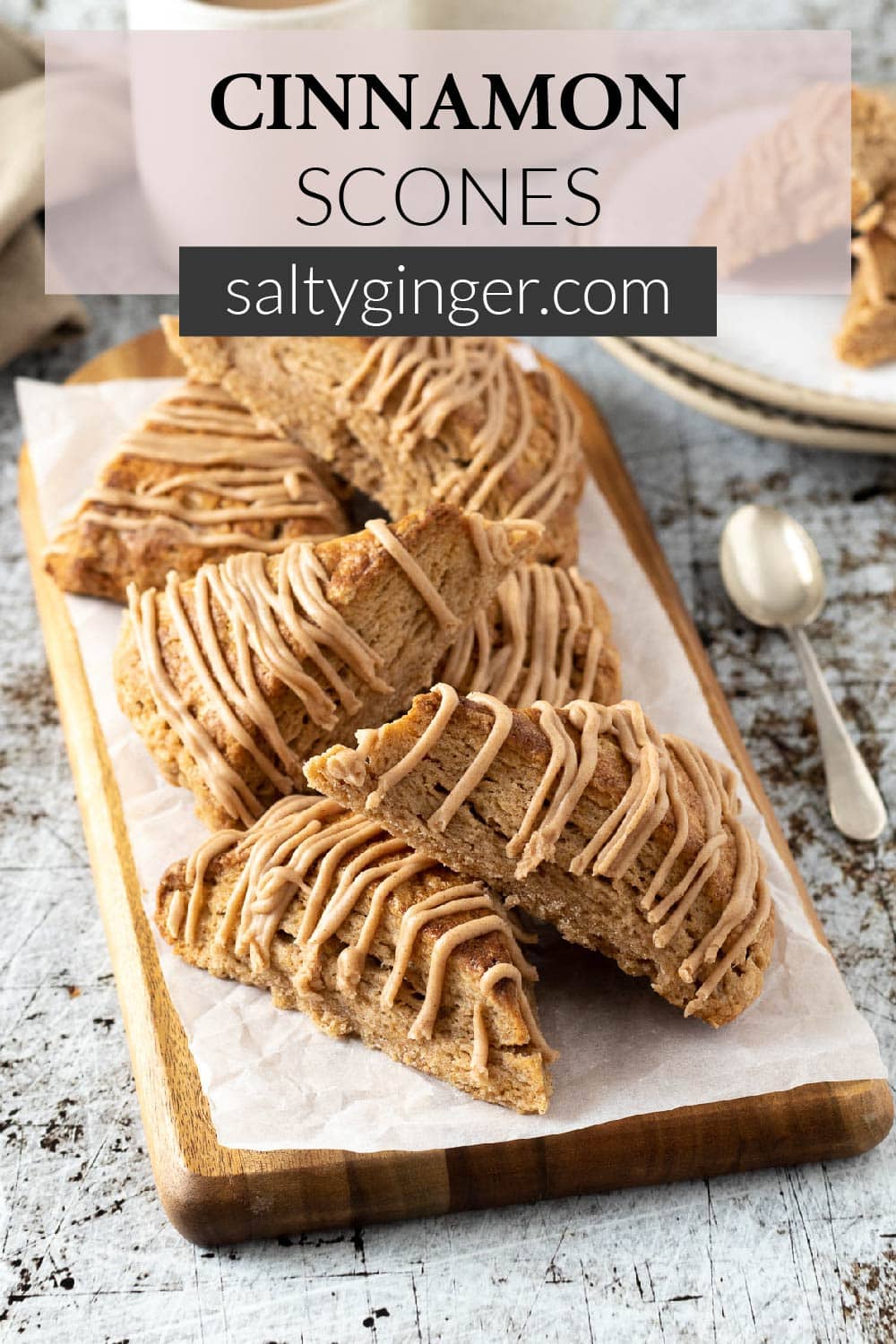 Pin - Cinnamon scones with a cinnamon glaze on a board.