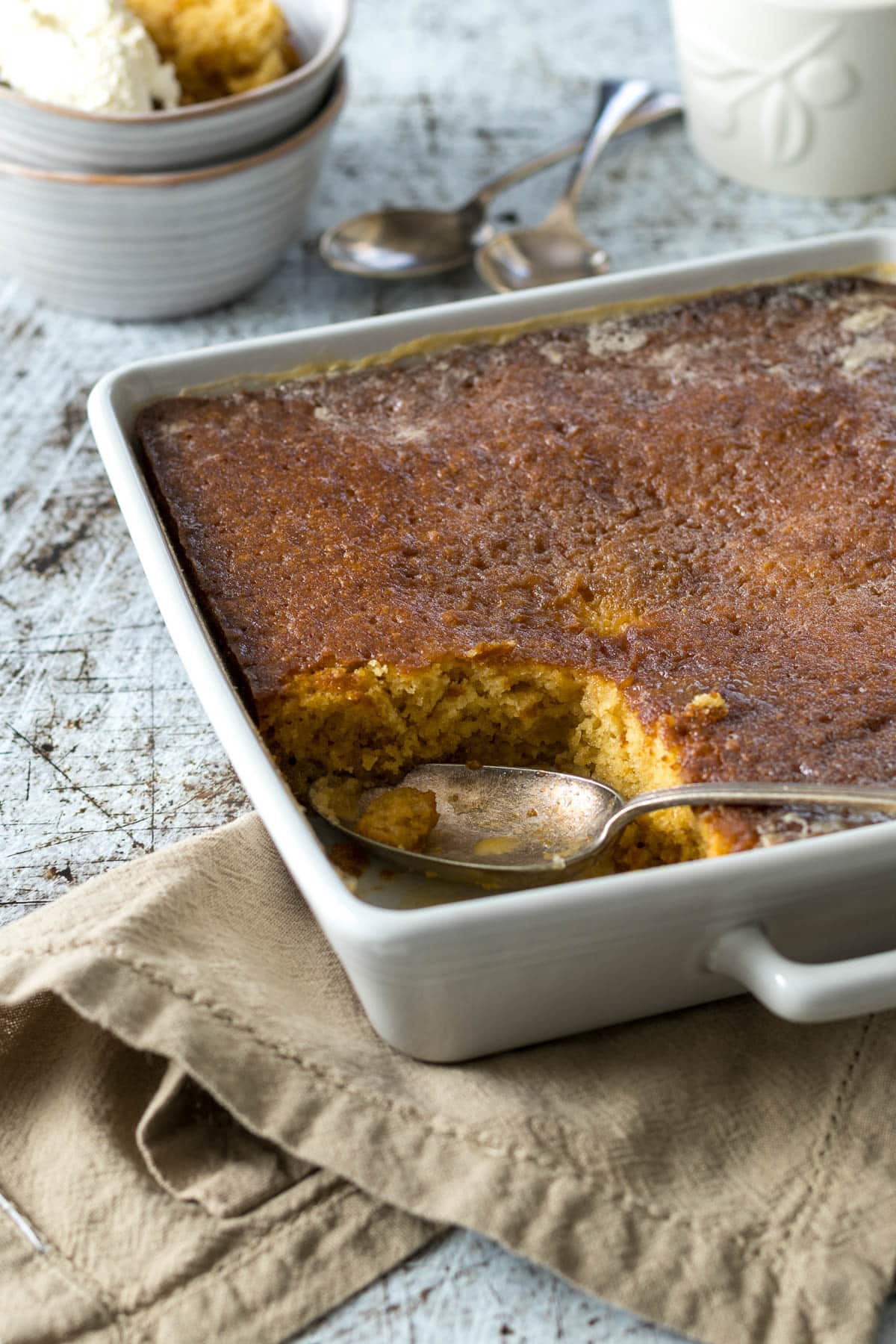 Baked Malva pudding with a portion scooped out.
