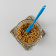 Step 4 - Biscuit crumbs combined with melted butter in a bowl.
