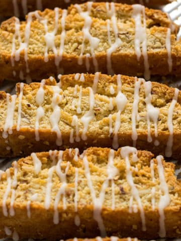 Lemon biscotti with a lemon glaze on a baking tray.