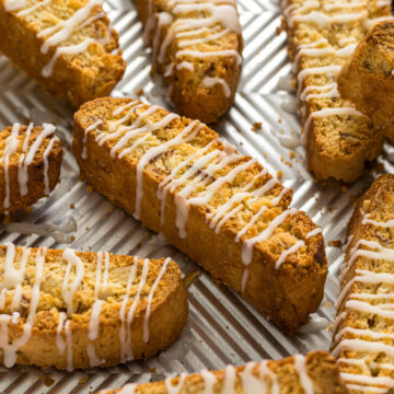 Lemon biscotti with a lemon glaze on a baking tray.