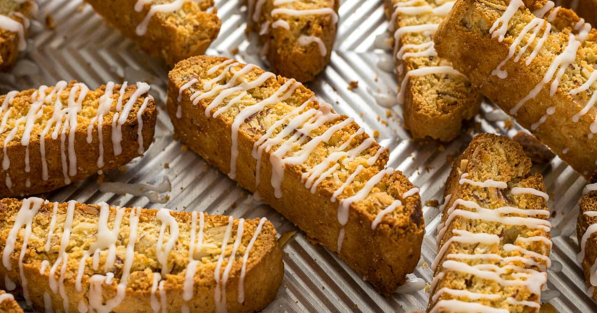 Lemon biscotti with a lemon glaze on a baking tray.