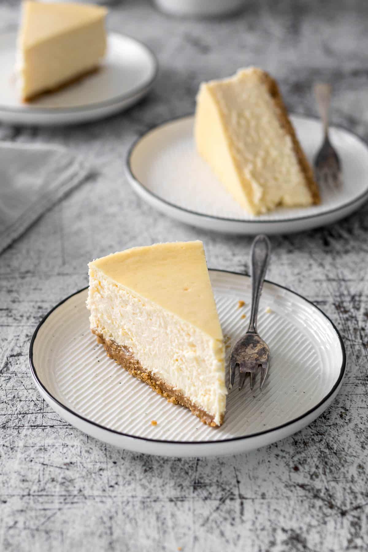 Slice of Philadelphia cheesecake on a plate.