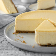 Sliced Philadelphia cheesecake on a serving plate.