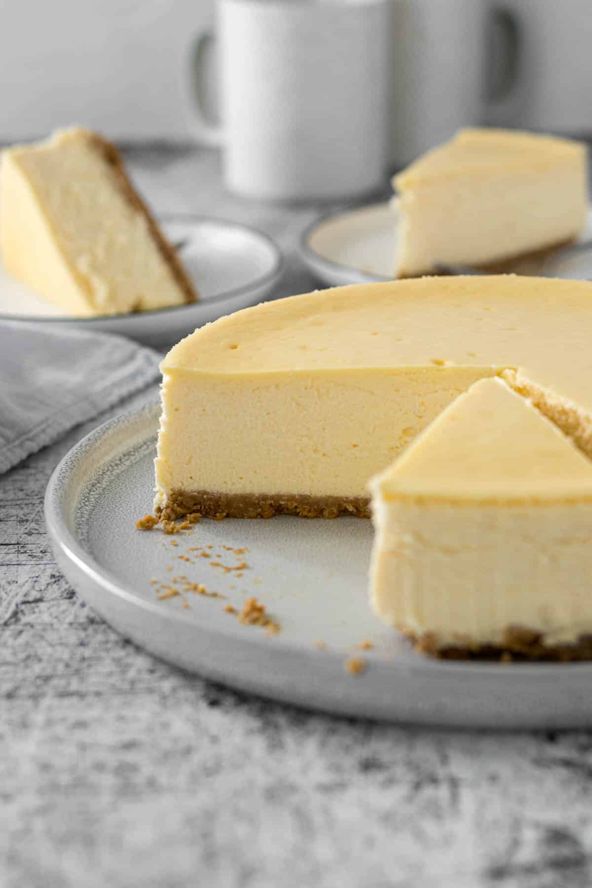 Sliced Philadelphia cheesecake on a serving plate.