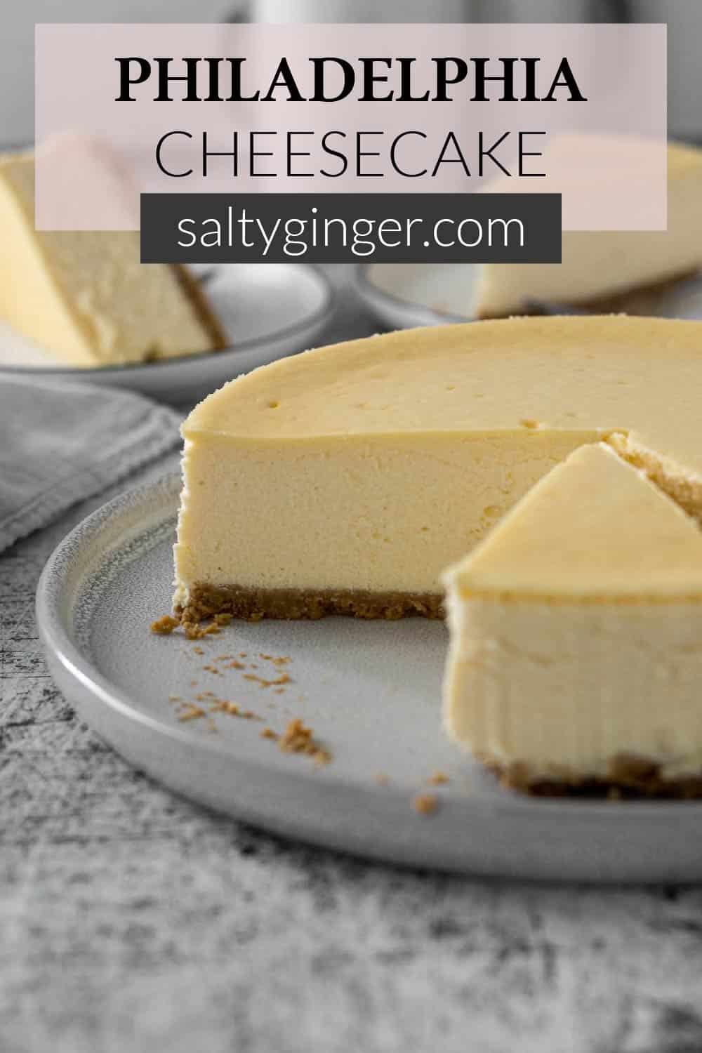 Pin - Sliced Philadelphia cheesecake on a serving plate.