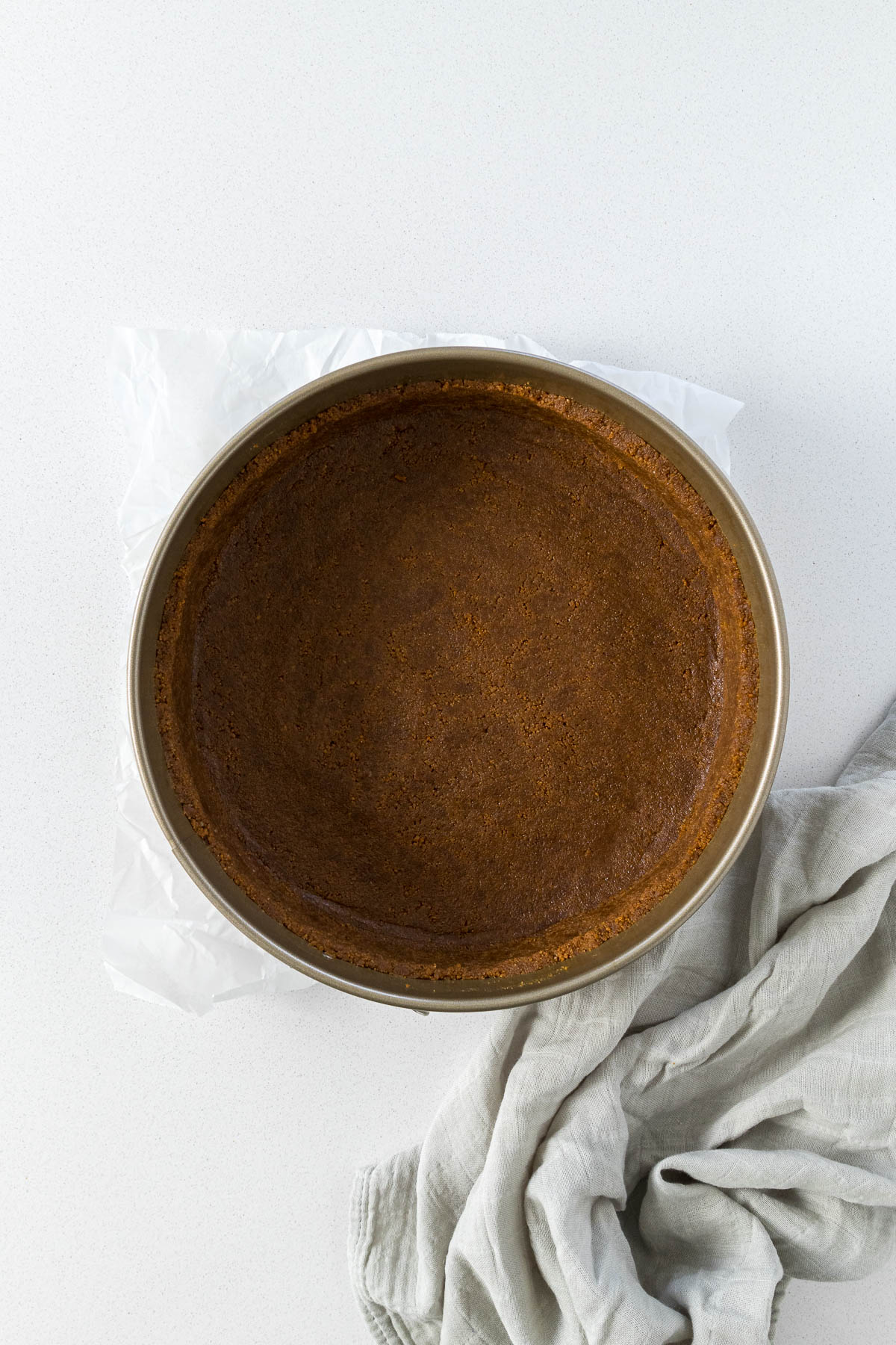 Step 5: Biscoff biscuit crumbs pressed into the bottom and sides of a springform cake pan.