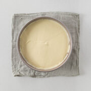 Step 10 - cheesecake filling smoothed over biscuit base.