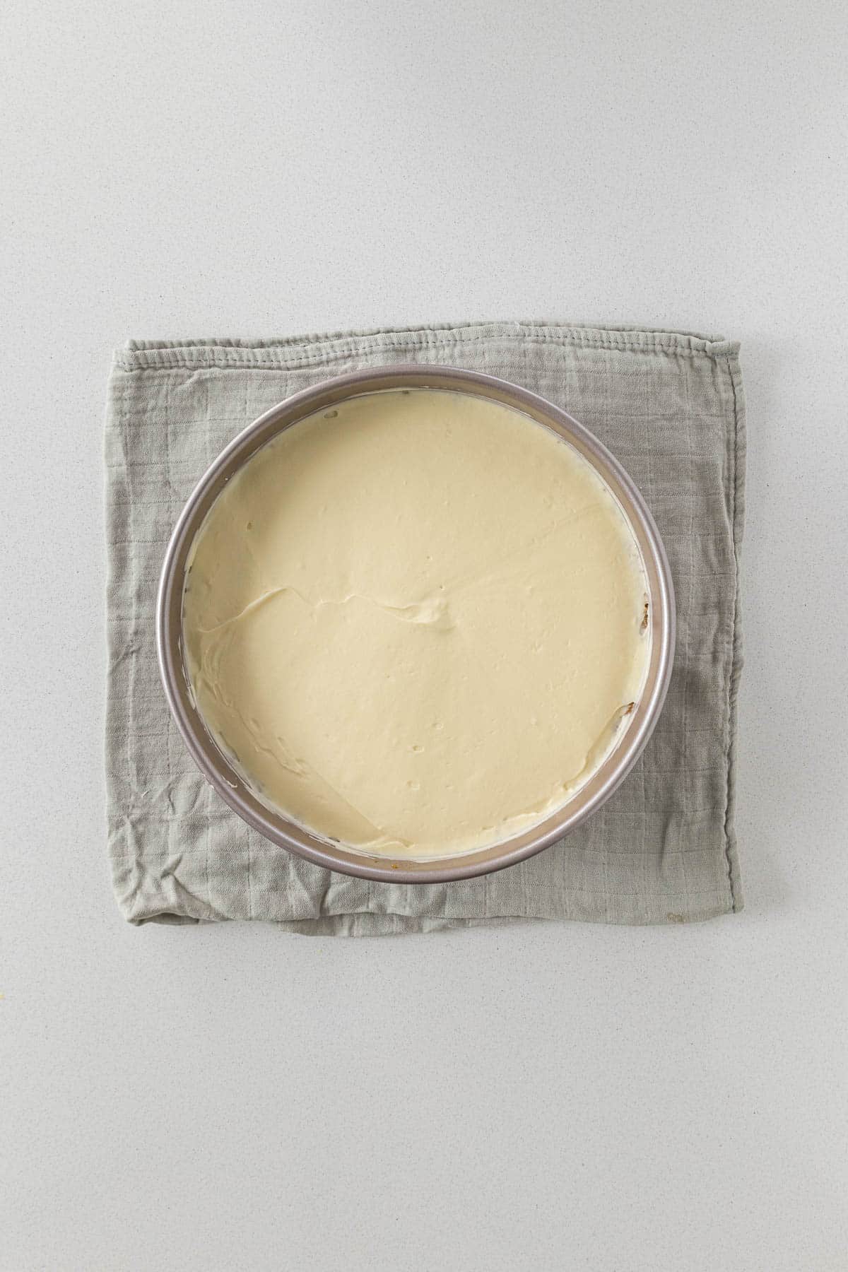 Step 10 - cheesecake filling smoothed over biscuit base.