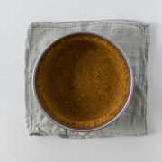 Step 5 - biscuit crumbs pressed into a loose-bottom cake pan.