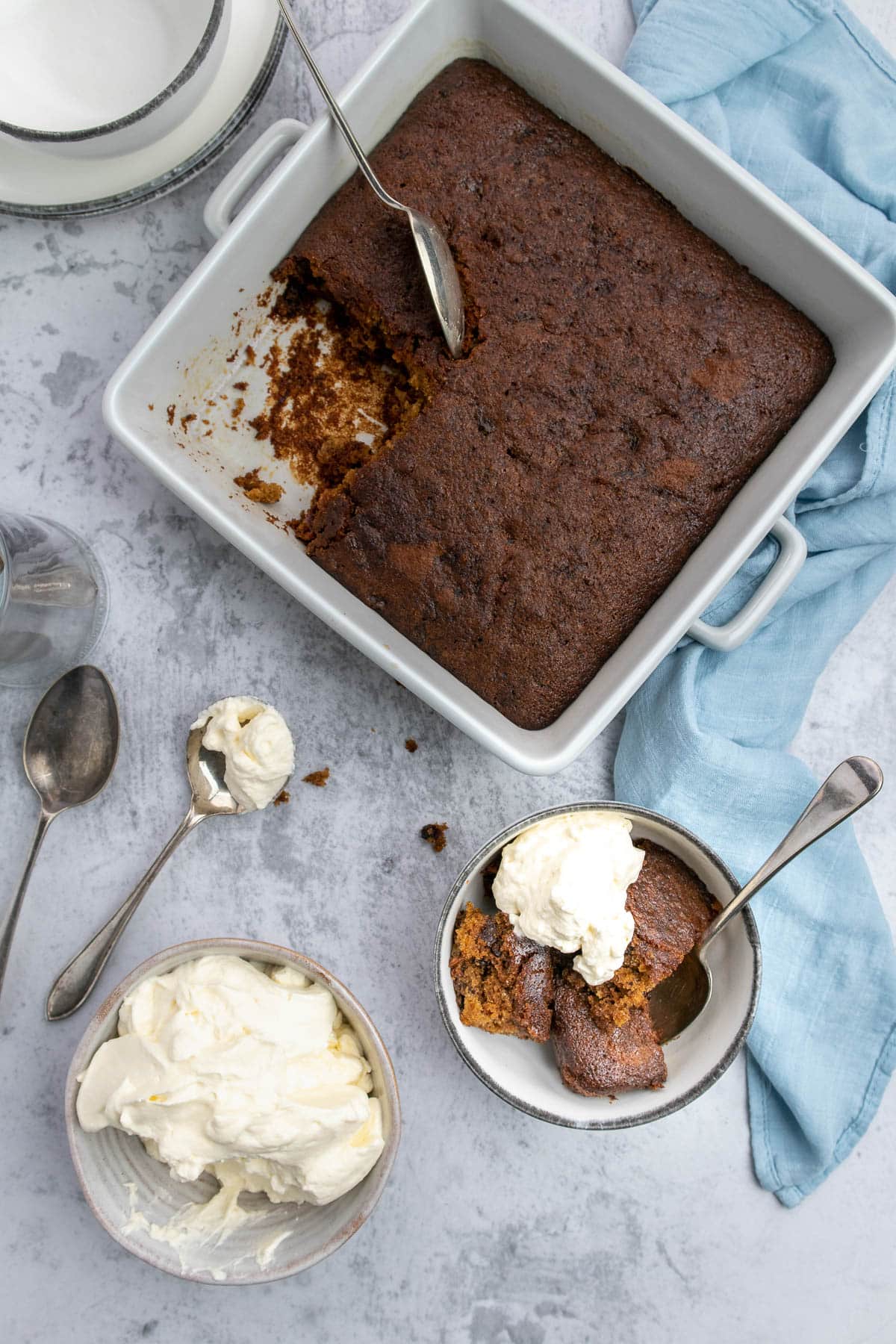 Cape brandy pudding dished up into a bowl with some whipped cream.