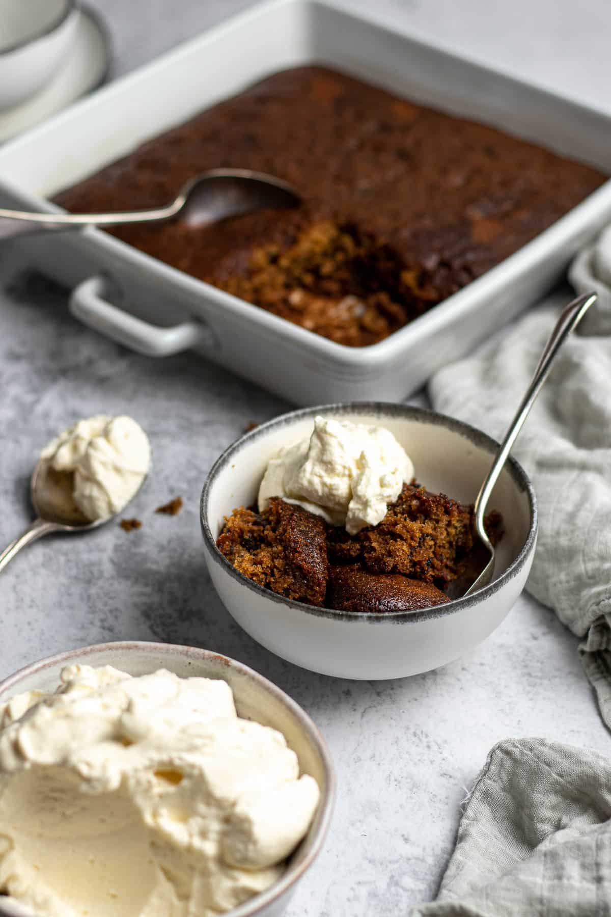 Tipsy tart dished up into a bowl with some whipped cream.