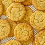 Vanilla sugar cookies strewn on a baking sheet.