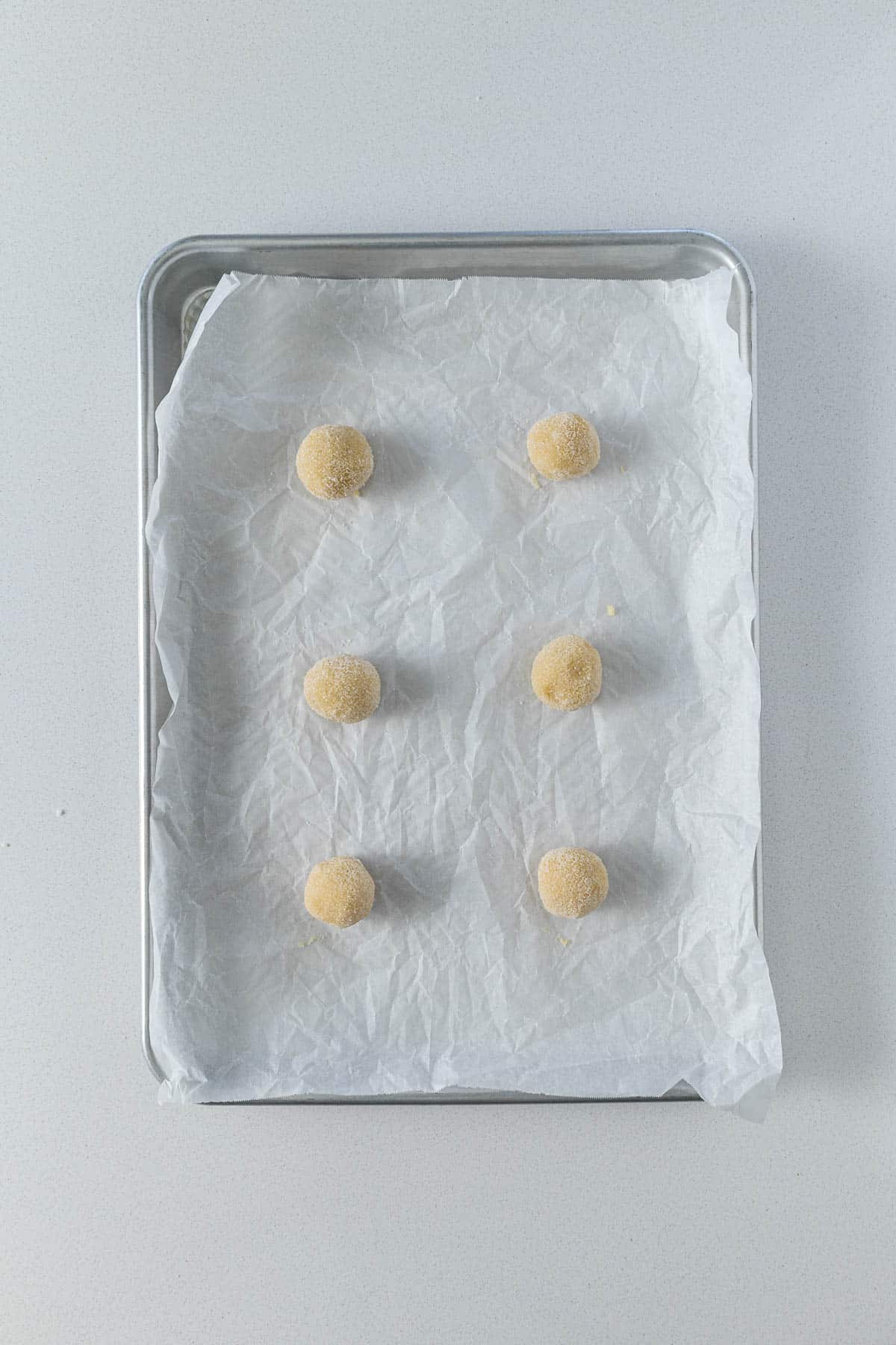 Step 6 - Cookie dough rolled in sugar and placed on a baking sheet ready for baking.