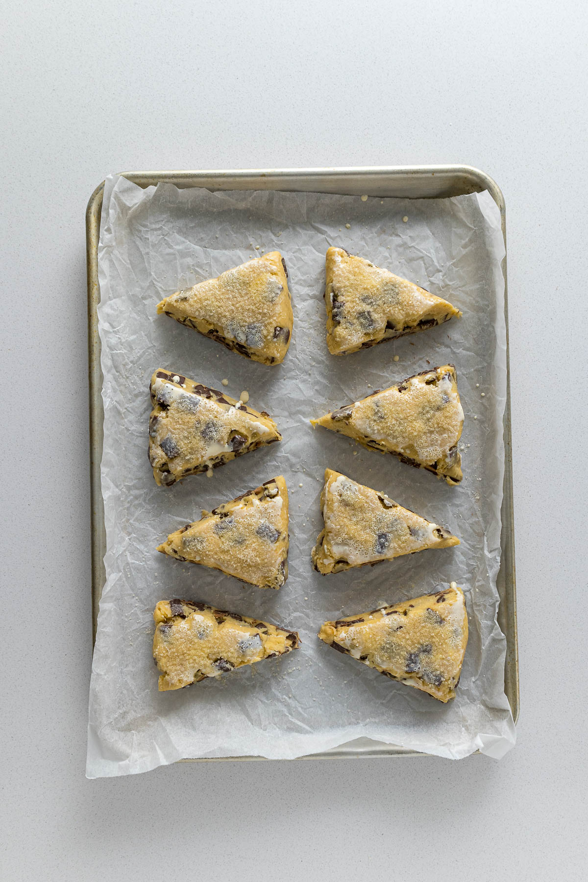 Step 7 - Scones brushed with cream and topped with coarse sugar before baking.