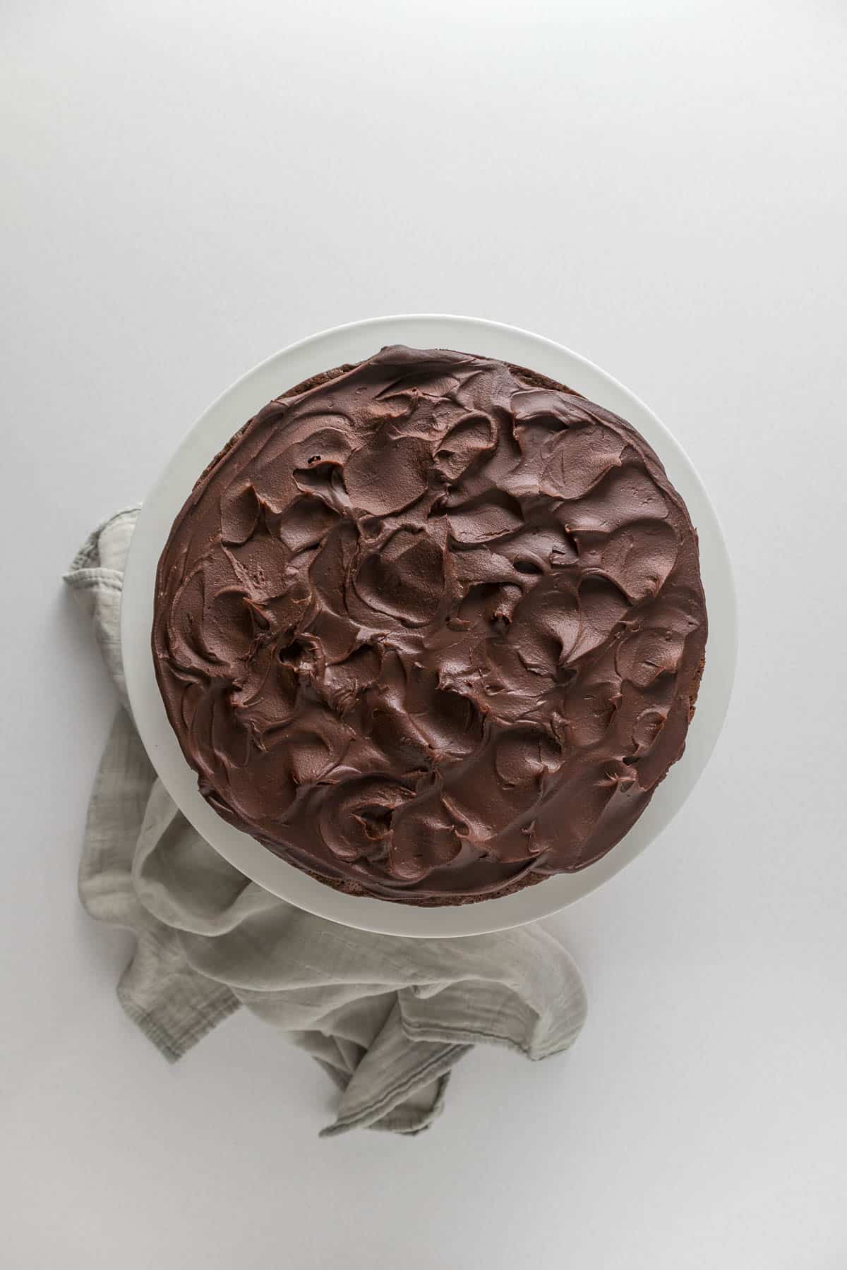 Step 11 - Chocolate ganache spread over the chocolate fudge cake.