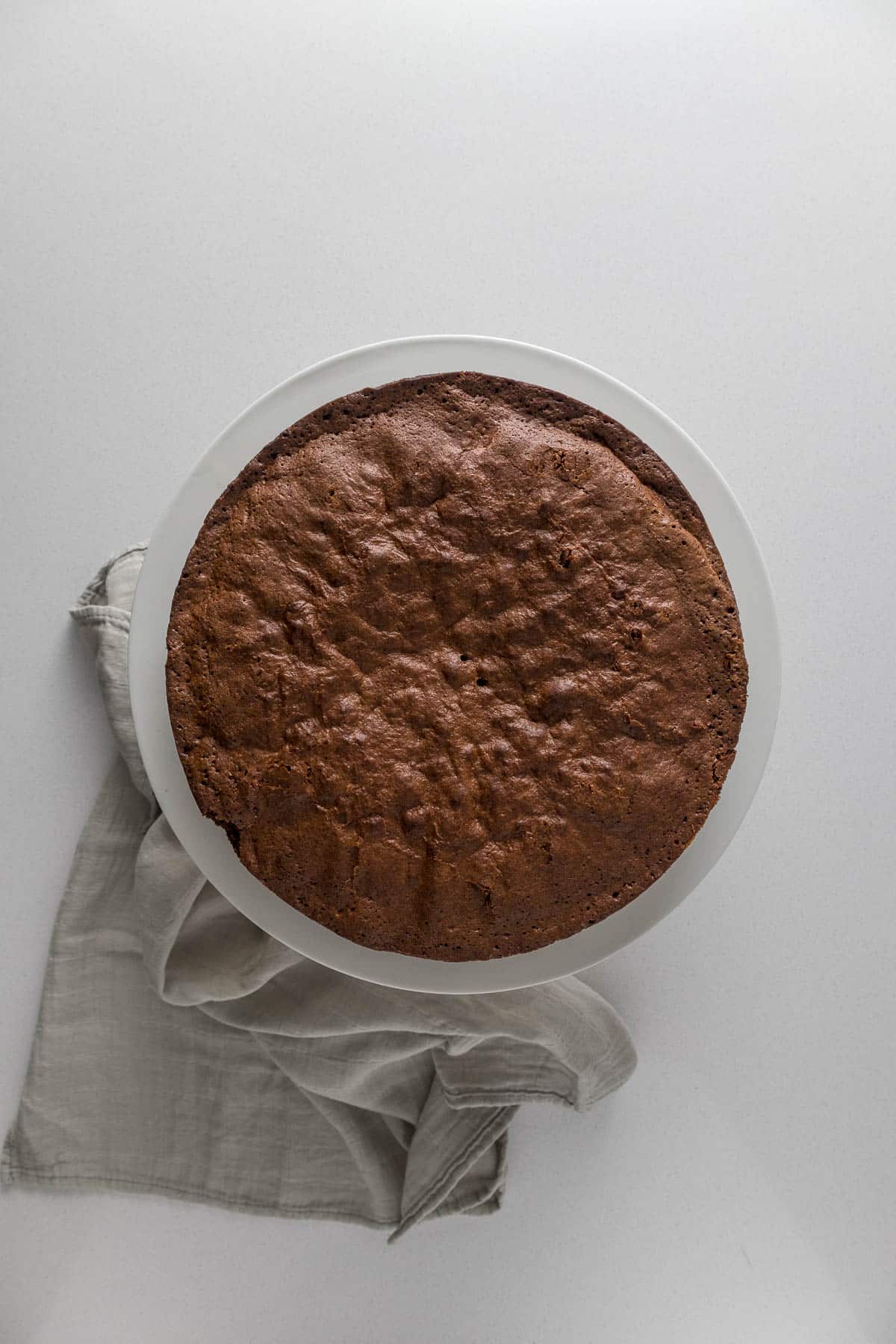 Step 11 - Baked chocolate fudge cake on a cake stand.