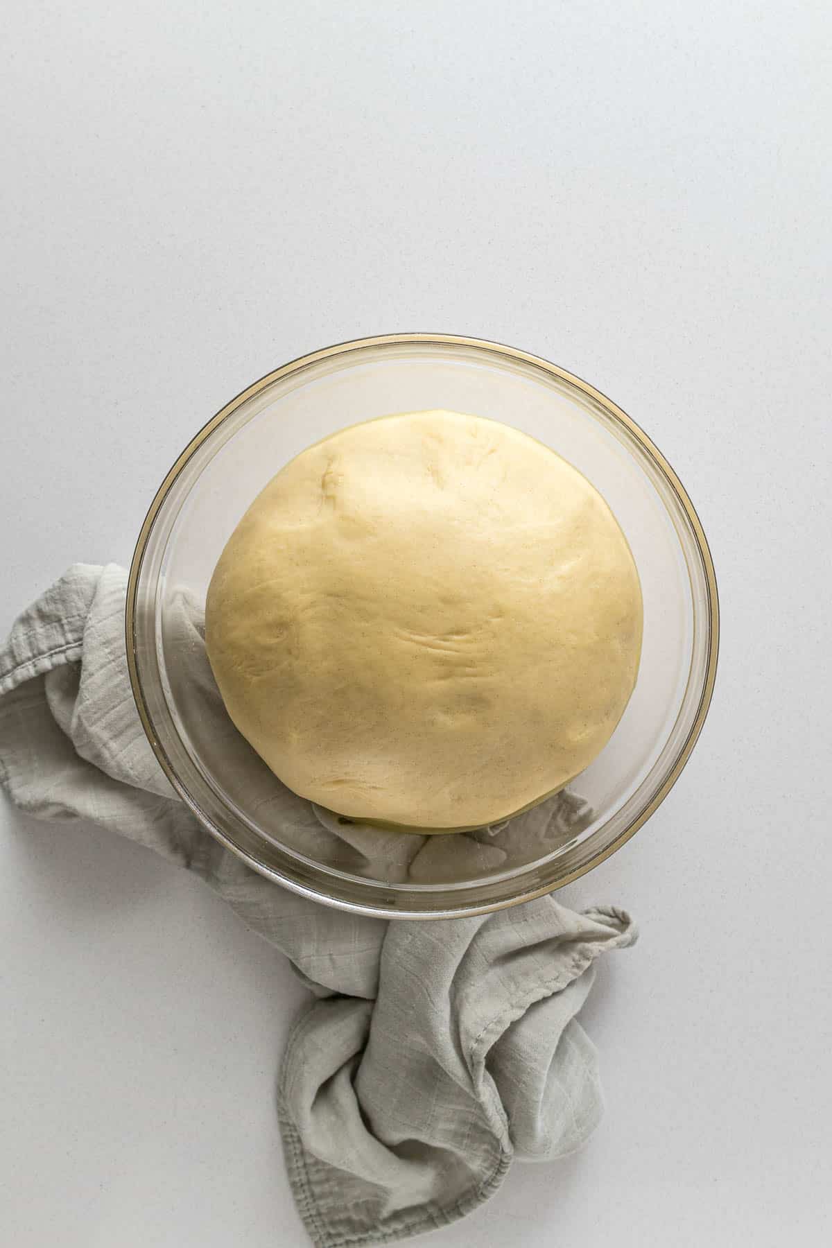 Step 5 - Proofed bread dough in a bowl, the dough has doubled in size.