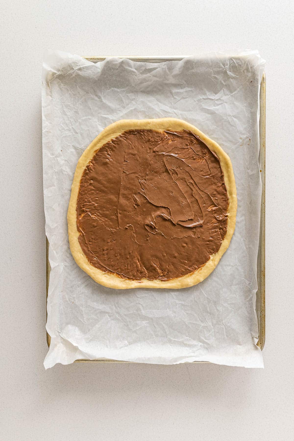 Step 8 - Nutella spread onto the first rolled out disc of bread.