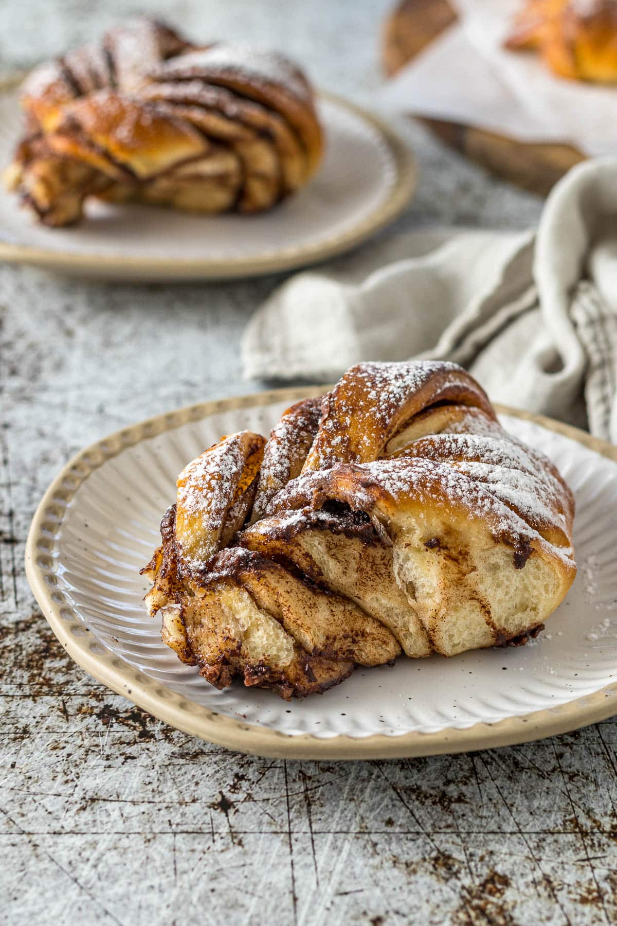Portion of Nutella bread dusted with powdered sugar on a plate.