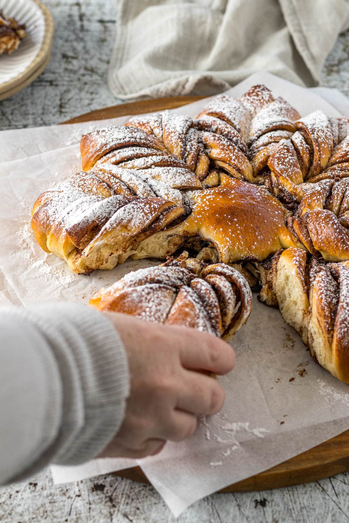 Portion of Nutella bread being picked up from the serving platter.