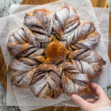 Nutella Star Bread dusted with powdered sugar on a serving platter.