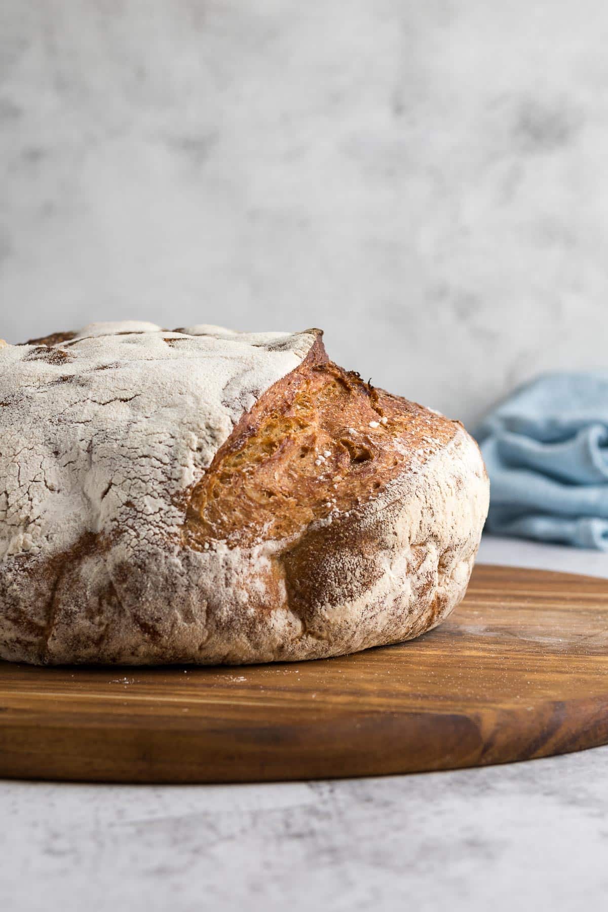 Loaf of country bread on a cutting board.