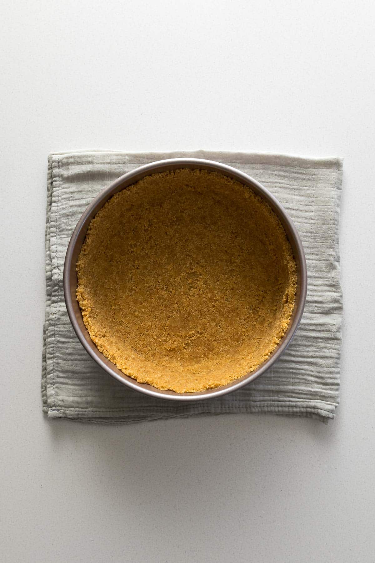Biscuit crust pressed into the bottom and up the sides of of the springform pan.