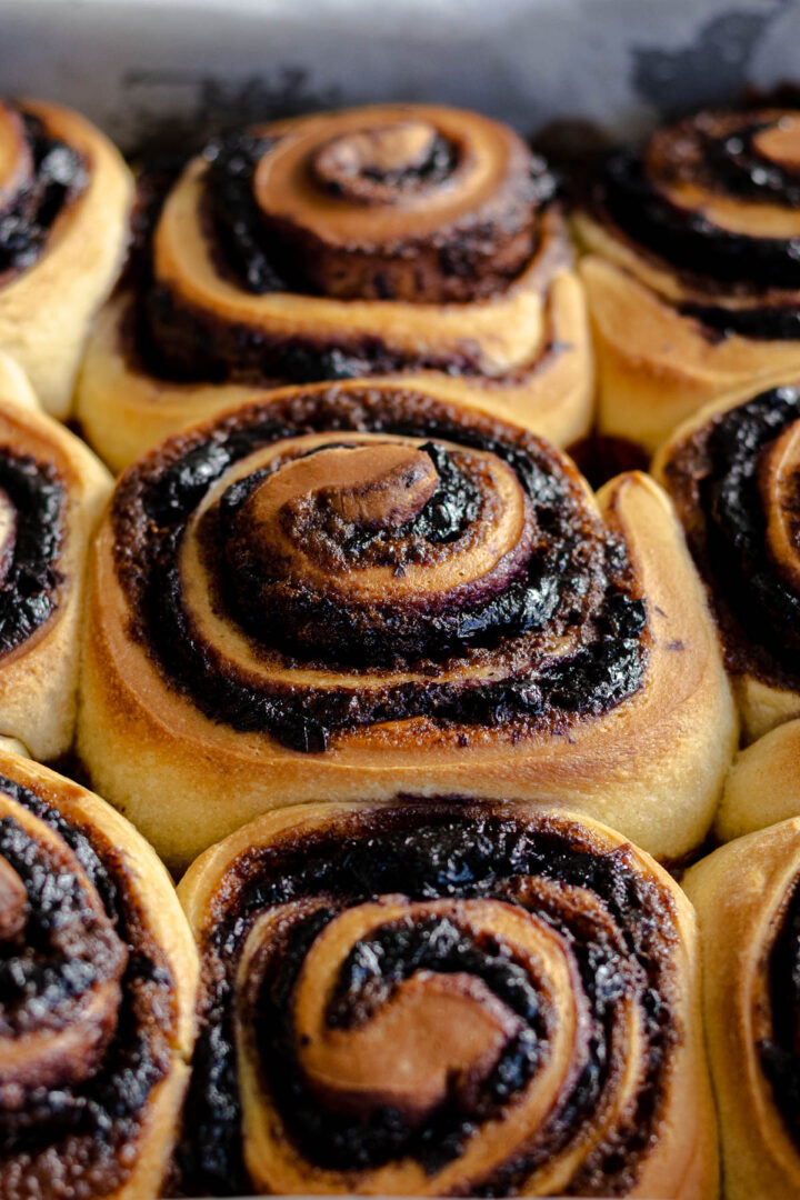 Unfrosted cinnamon blueberry rolls showing the cinnamon blueberry filling.