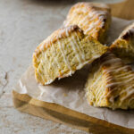 Lemon poppy sedd scones on a wooden board.