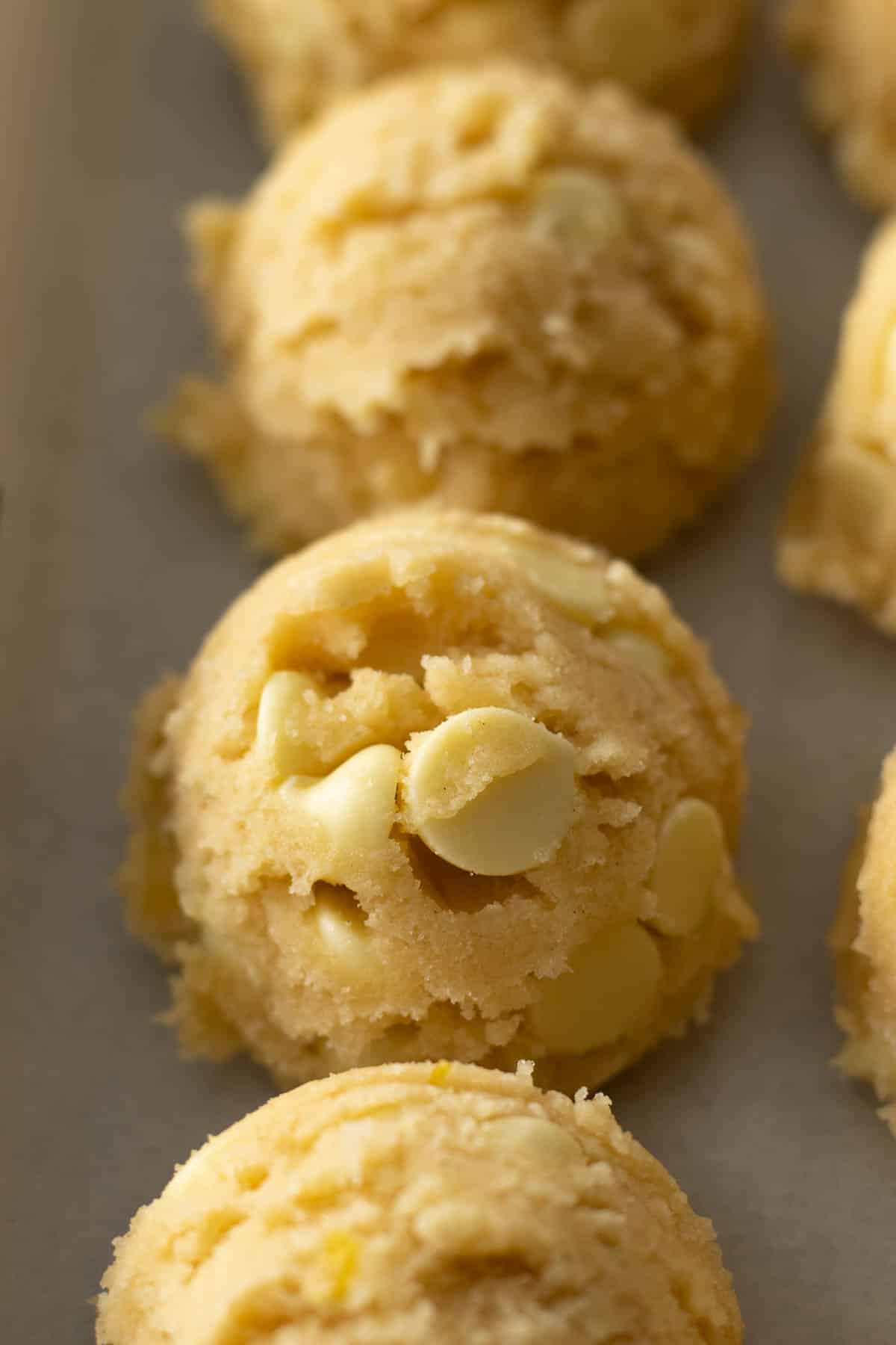 Step 7 - Lemon white chocolate cookies portioned and placed on a baking tray.