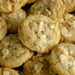 White chocolate and lemon cookies on a baking tray.