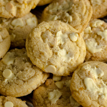 White chocolate and lemon cookies on a baking tray.
