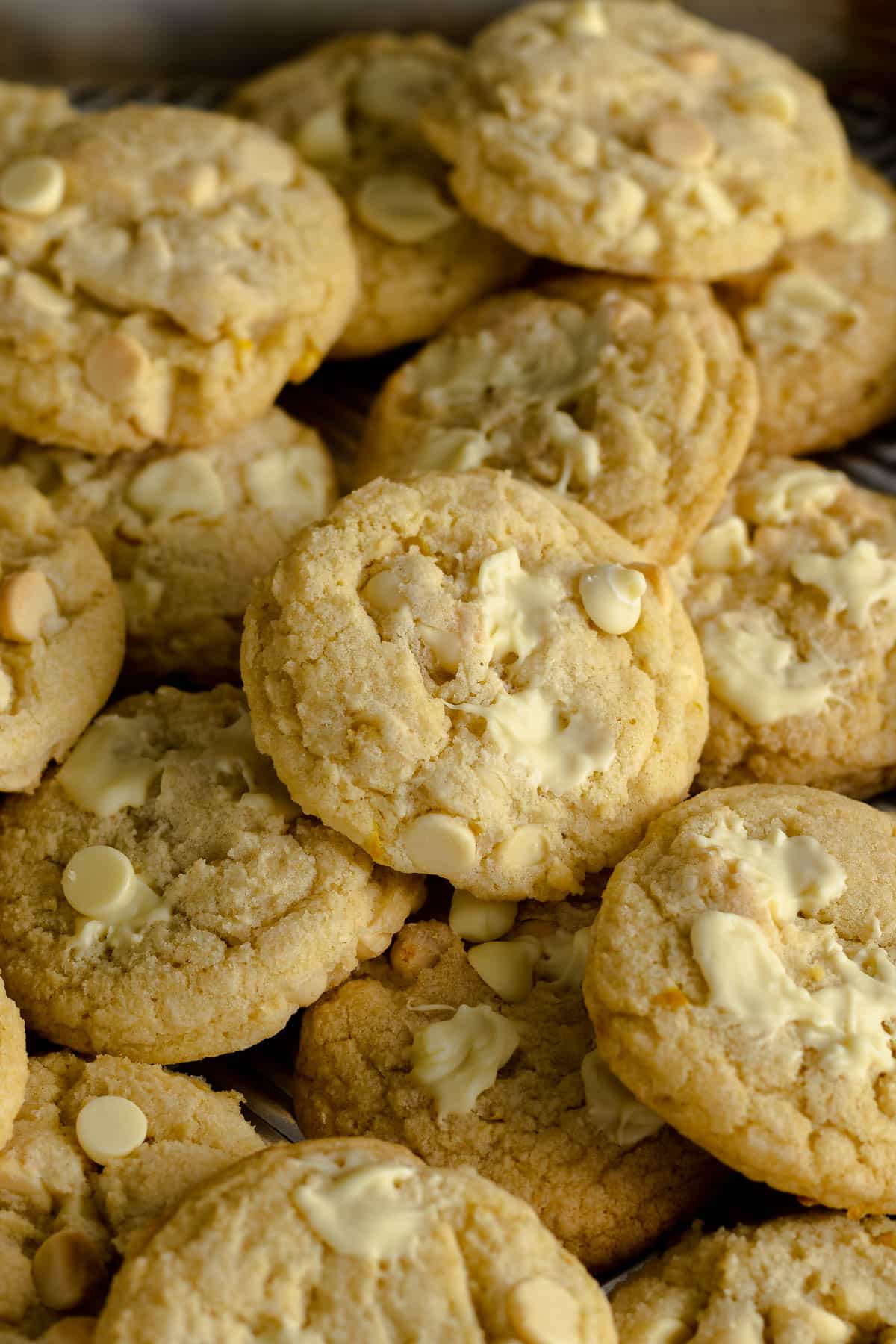 Lemon and white chocolate chip cookies on a baking tray.