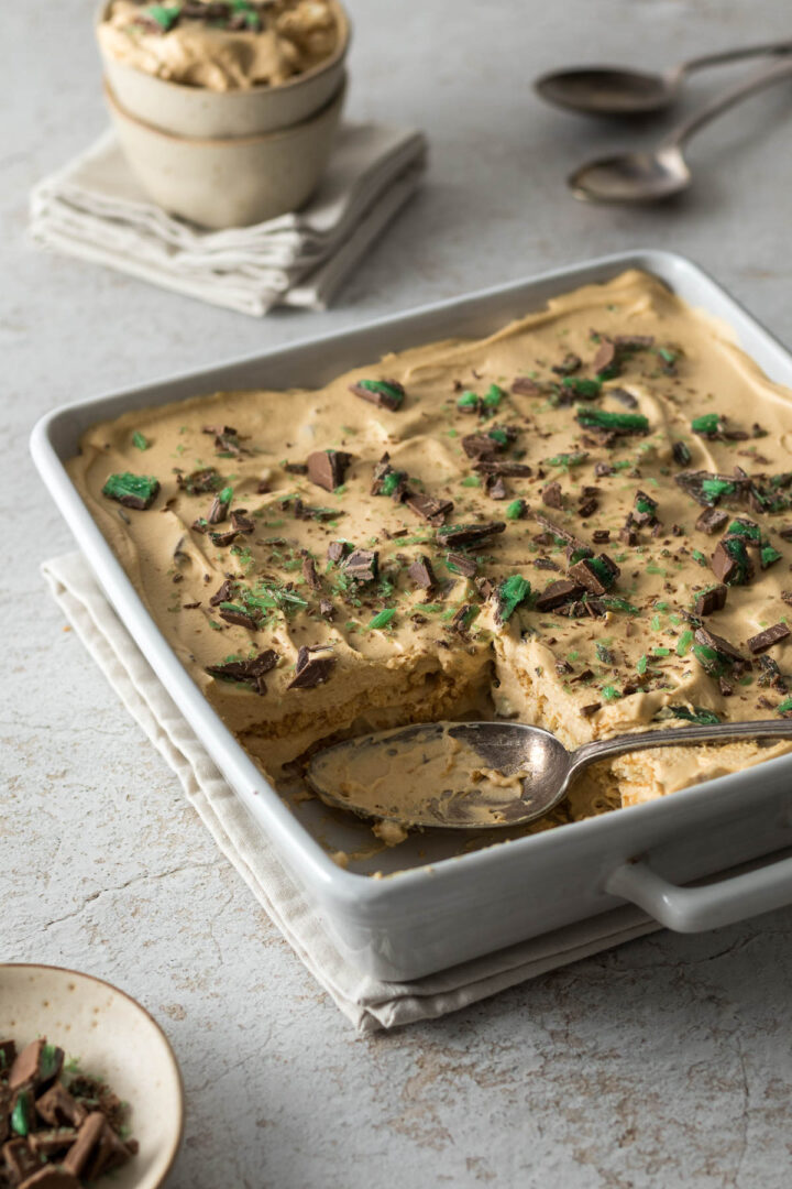 Peppermint crisp tart in a serving dish with a serving spoon.