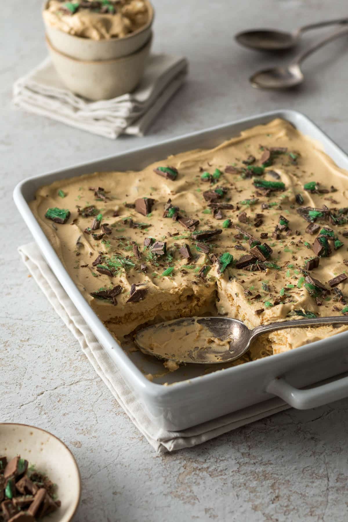 Peppermint crisp tart in a serving dish with a serving spoon.