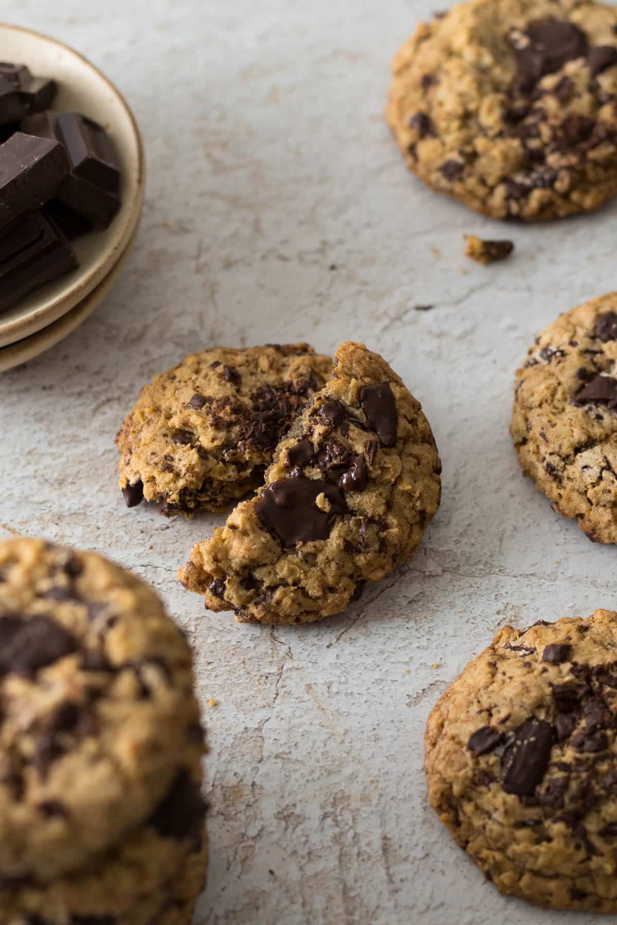 Chocolate chip oatmeal cookie broken in half.