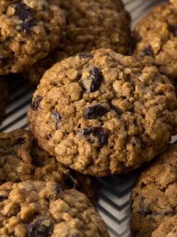 Oatmeal cookies with raisins on a baking tray.